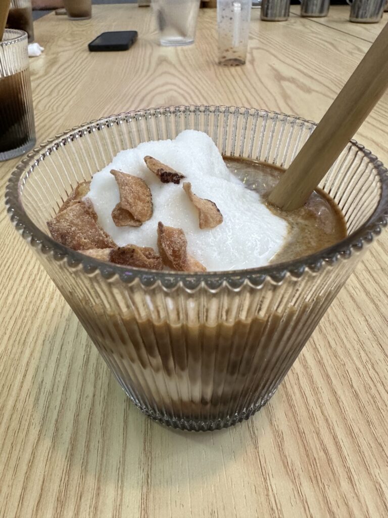 Homemade coconut coffee from a Vietnamese coffee workshop in Da Nang, served in a clear glass.